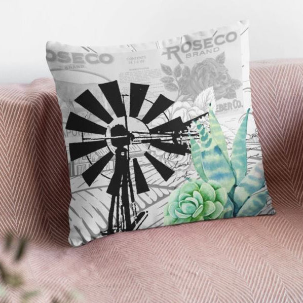 Decorative pillows on a sofa with a windmill design and succulent pattern.