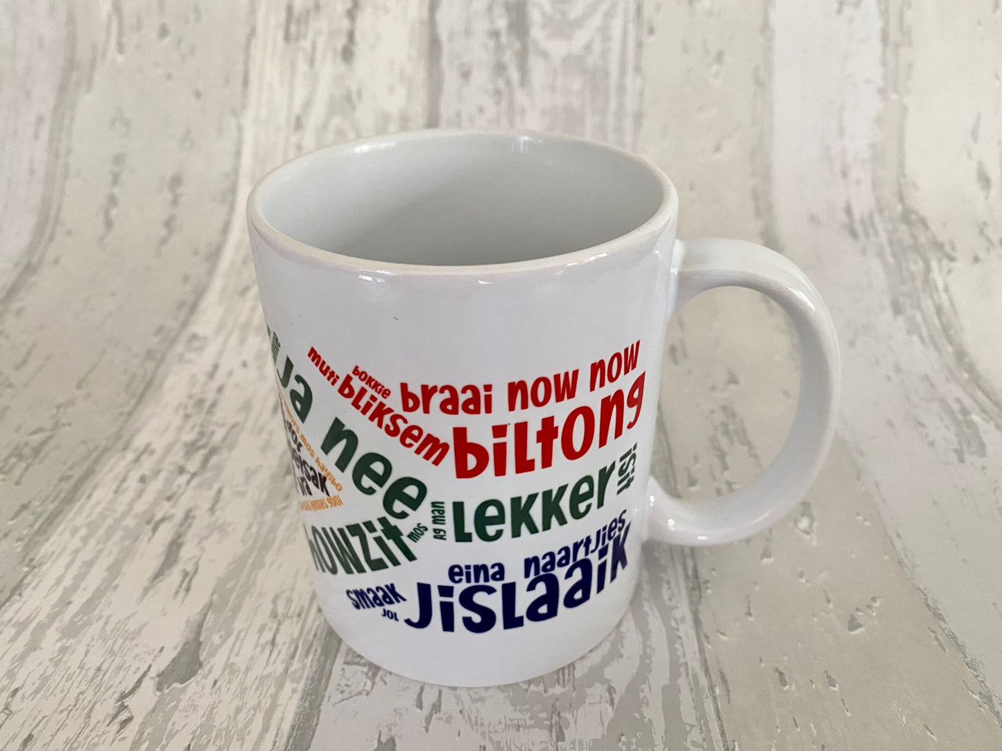 South African slang sayings in the South African flag 11oz mug. Afrikaans slang. SAFFA mug. Flag Art.