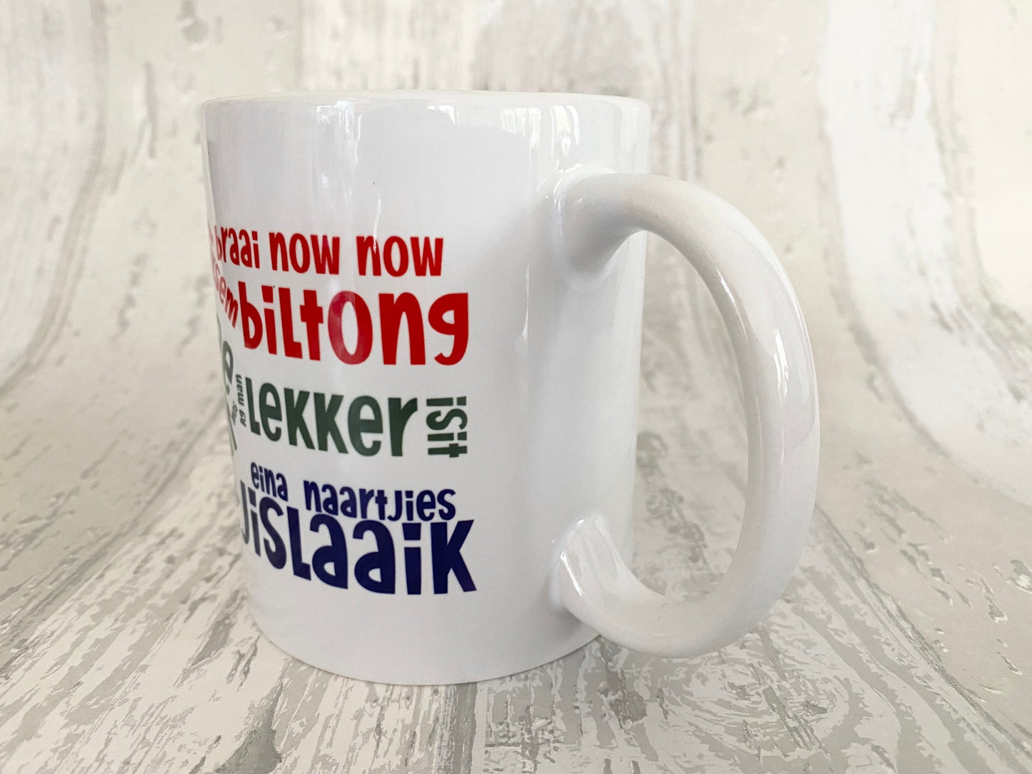 South African slang sayings in the South African flag 11oz mug. Afrikaans slang. SAFFA mug. Flag Art.