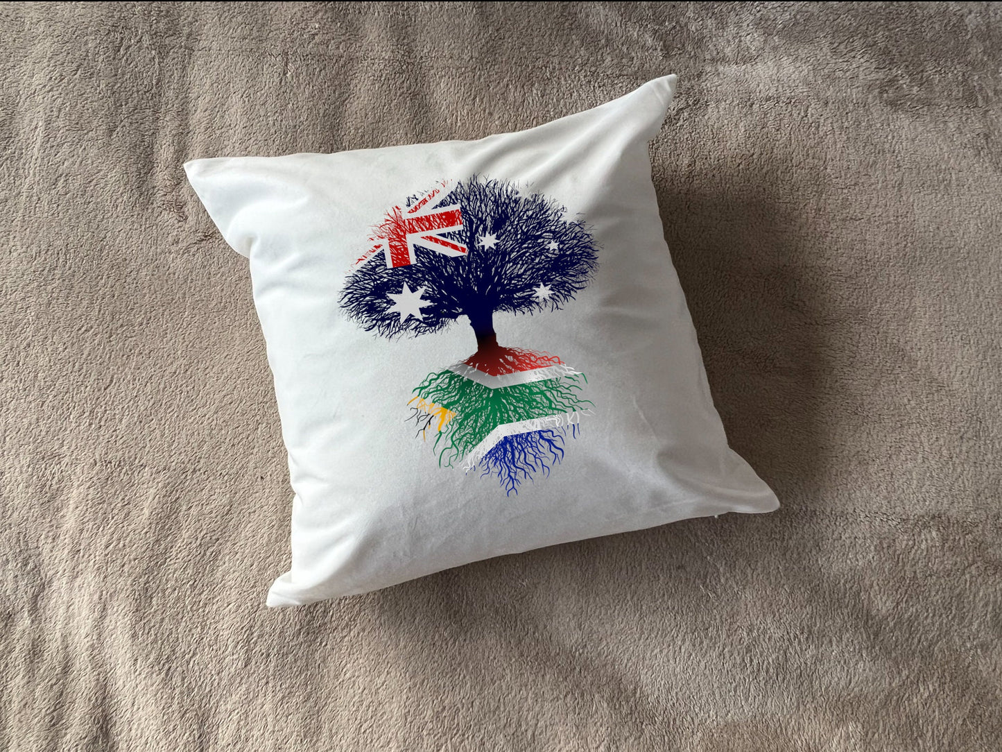 South African heritage cushion Australian flag tree with South African flag roots. Plush white cushion, ideal gift.