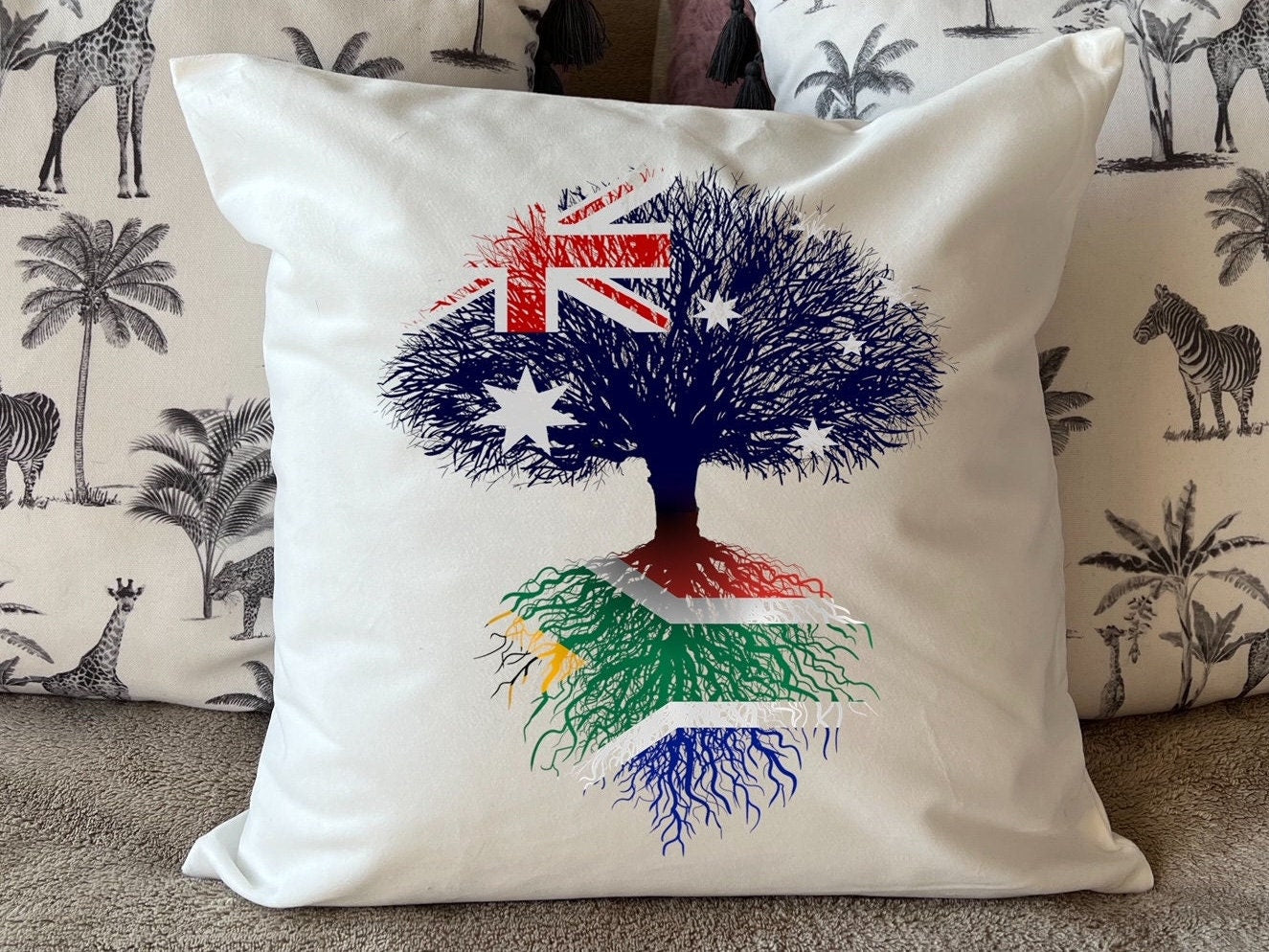 South African heritage cushion Australian flag tree with South African flag roots. Plush white cushion, ideal gift.