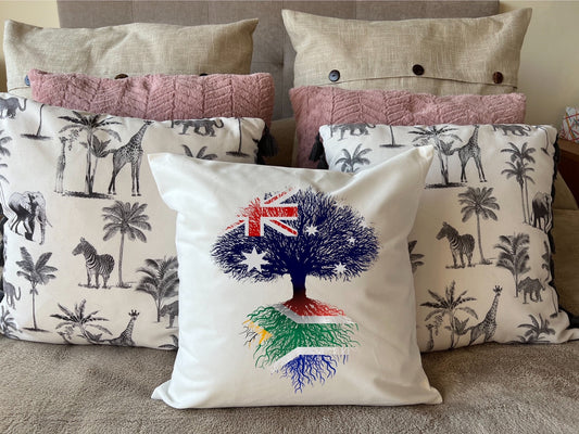 South African heritage cushion Australian flag tree with South African flag roots. Plush white cushion, ideal gift.